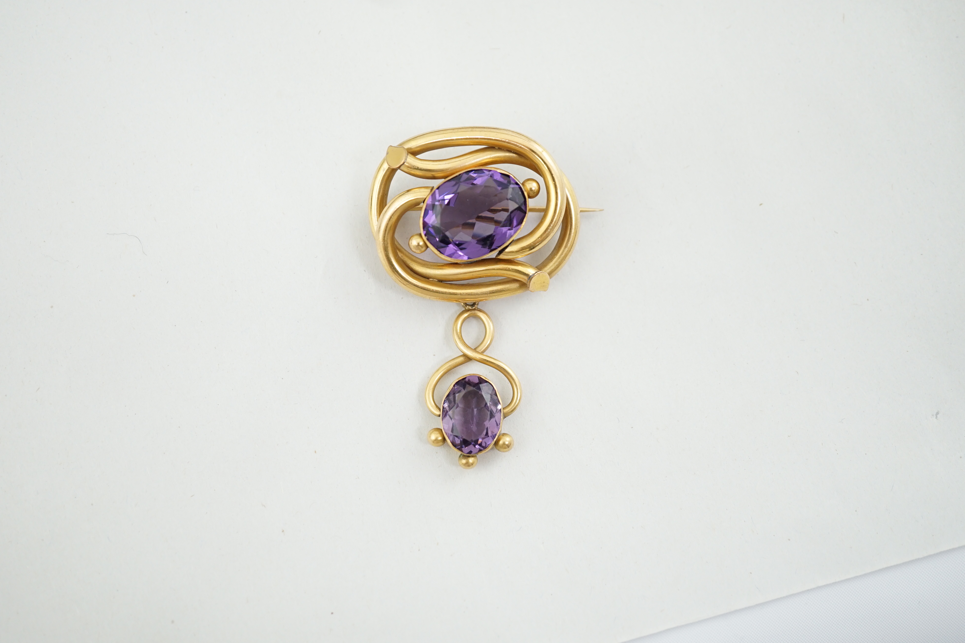 A Victorian gilt metal and two stone amethyst set drop brooch